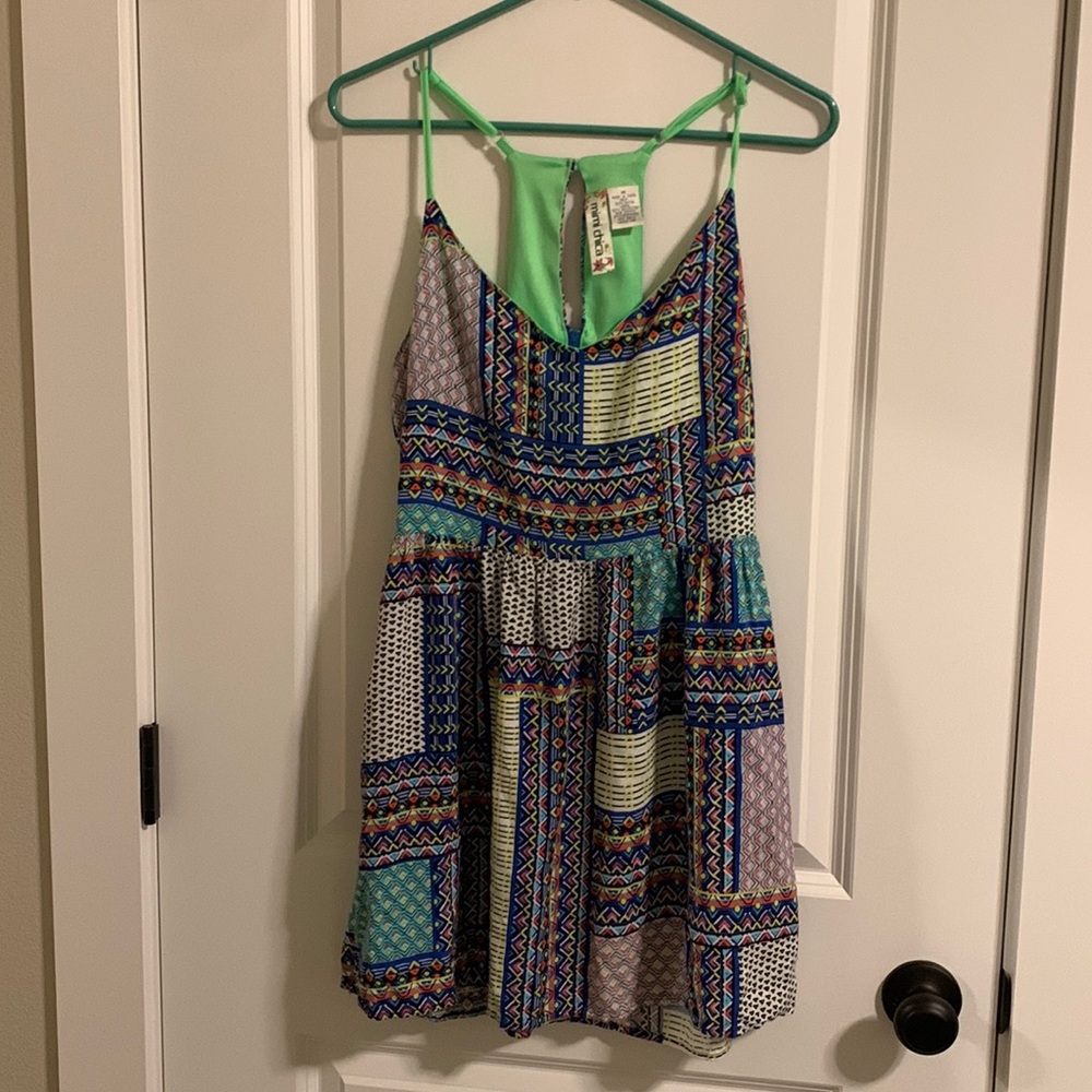 Cut outs on the back.  Racerback with a button closer and zipper.l
